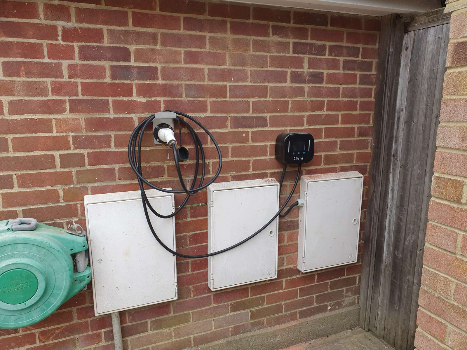 Wall-mounted EV charger installed by Dew Electrics